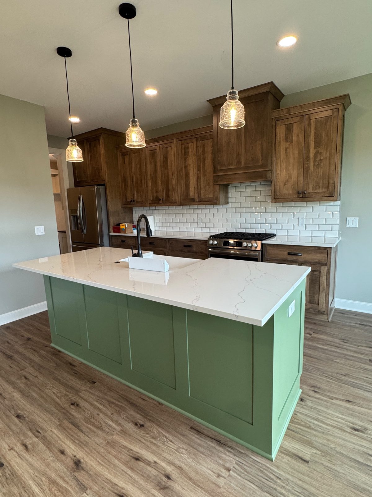 New kitchen with green island after post-construction cleaning