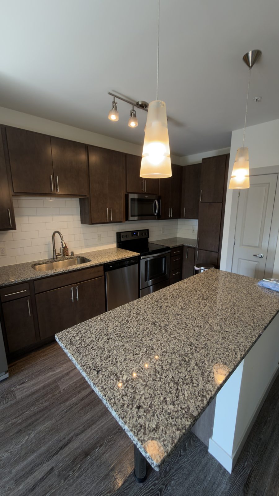 Kitchen with granite island after turnover cleaning
