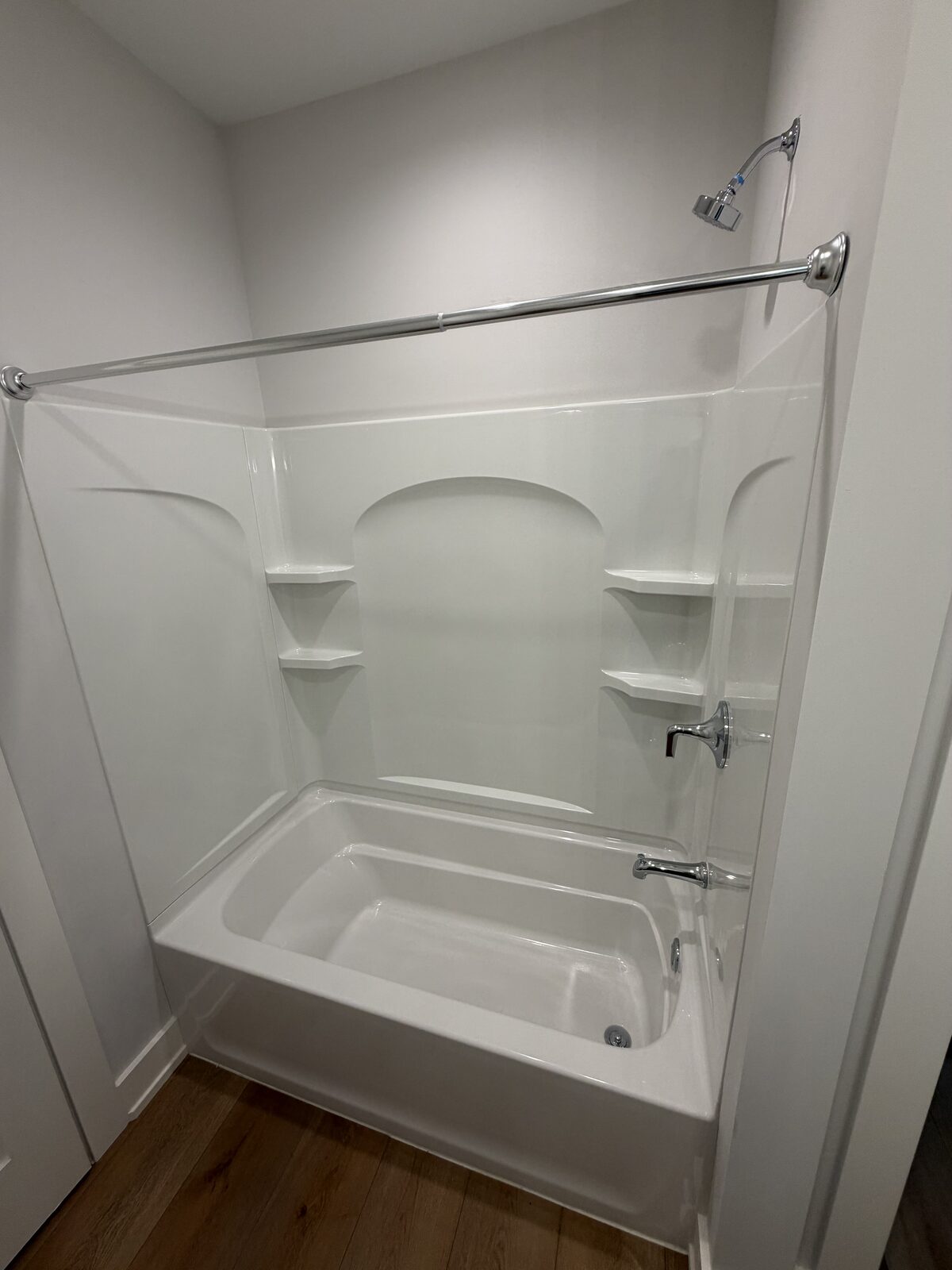 Tub and shower surround scrubbed spotless by IBS Cleaning Services